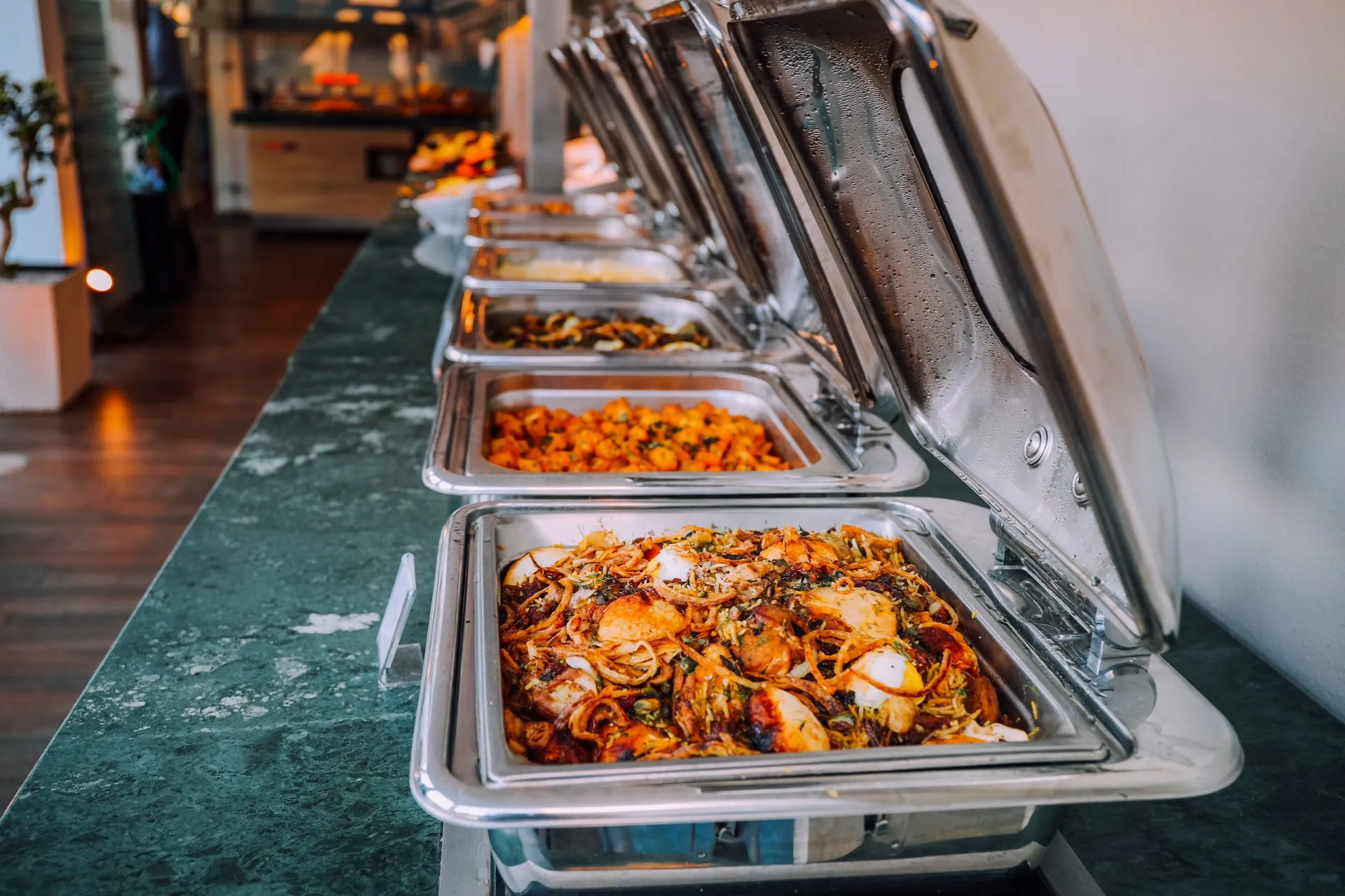 Luxurious catering buffet with chafing dishes of biryani and curries (illustrative photo)