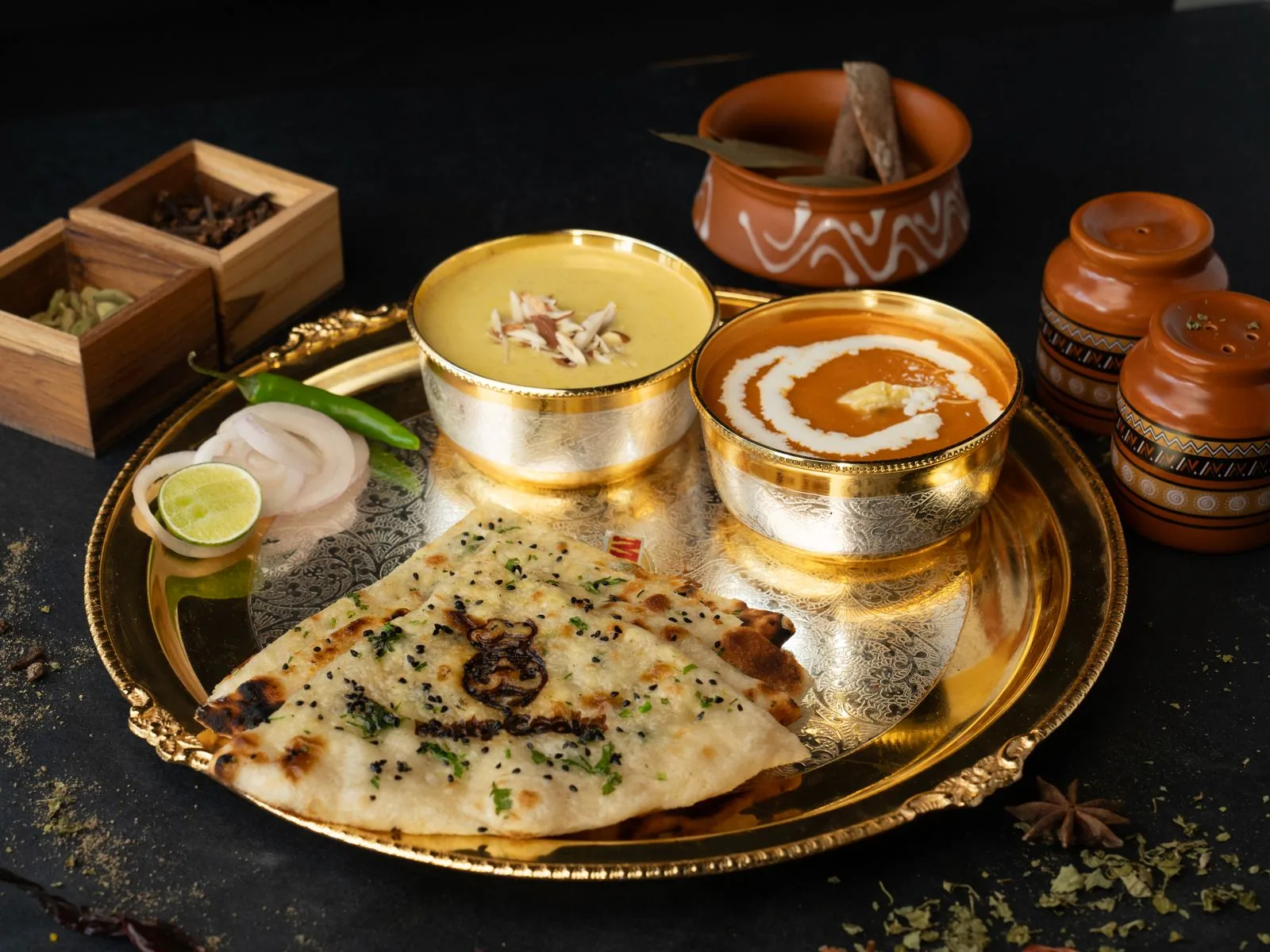Elegant North Indian thali with dal, butter chicken, naan and kheer for a Walima dinner (illustrative photo)